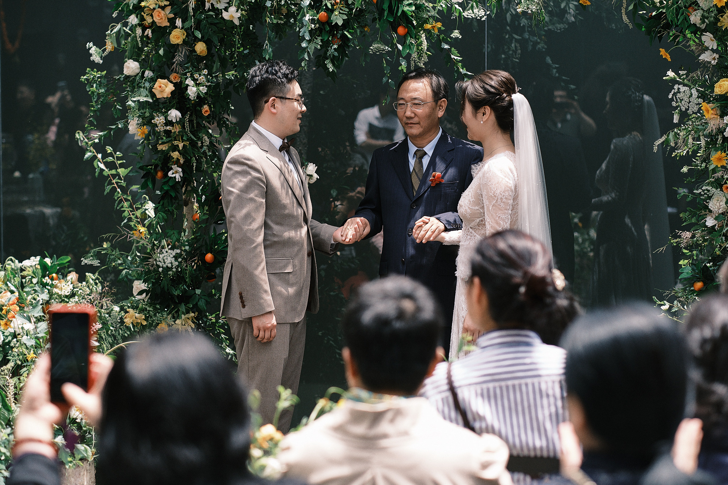 father of bride hold hands of bride and groom shanghai