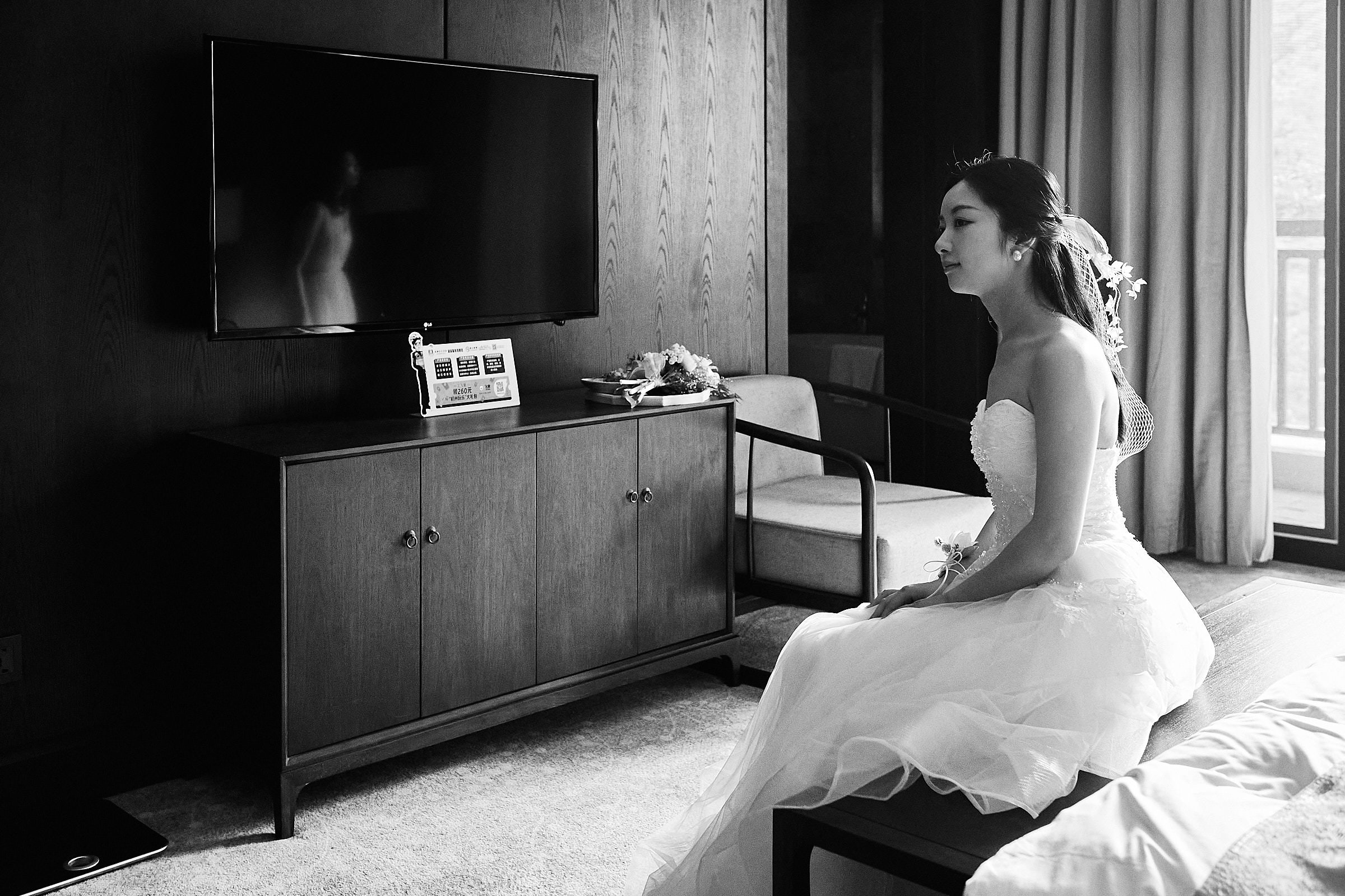 Bride Awaits Groom While Sitting On The Bed The Morning Of The Wedding.