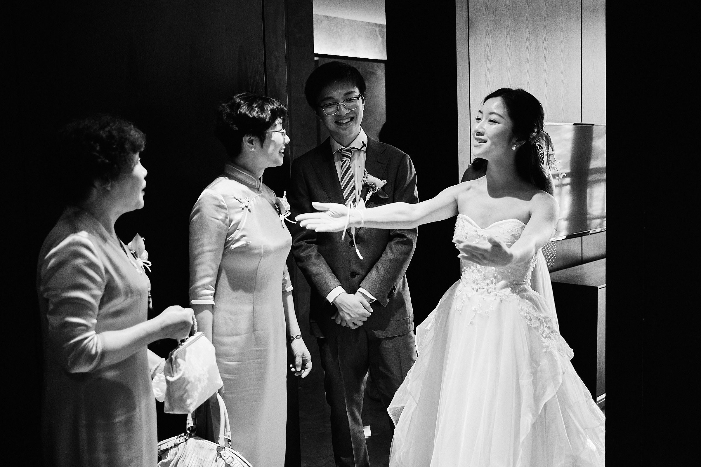 Black And White Image Of Bride Welcoming Her Family Members