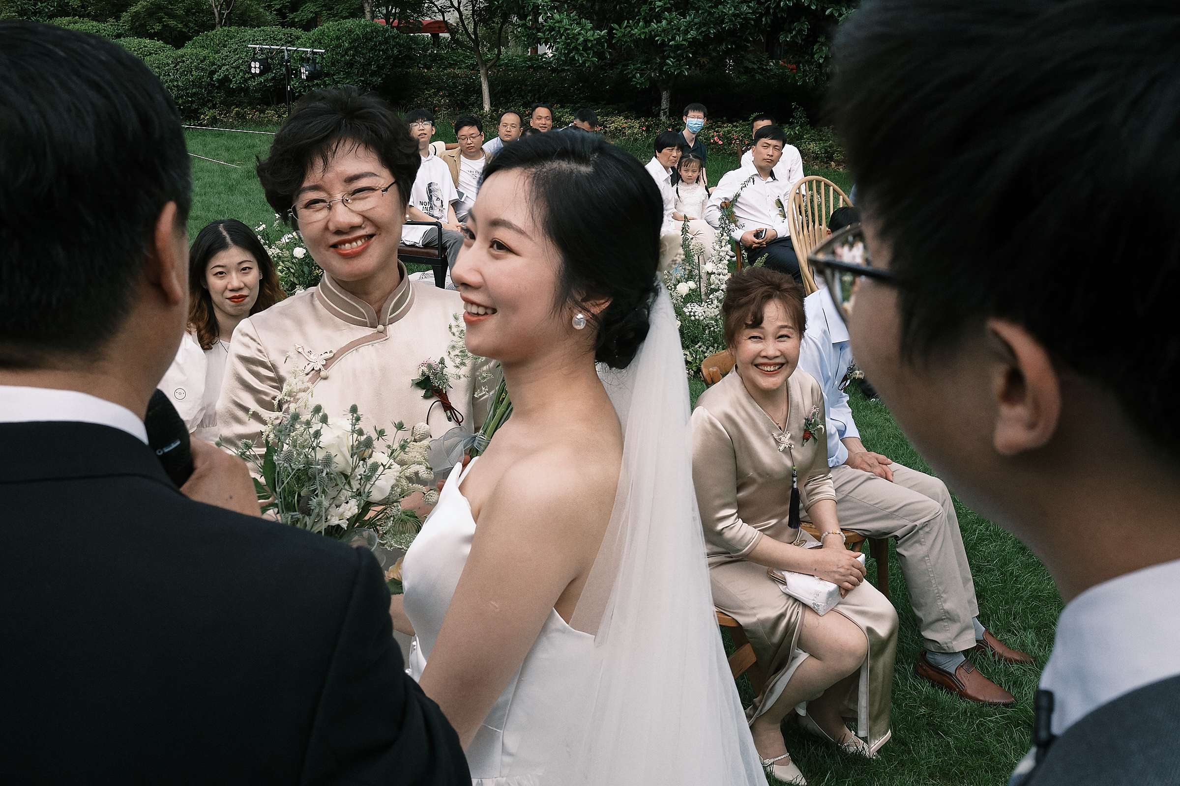 Bride And Her Mom Look At Officiant In Front Of All The Wedding Guests In Hangzhou China