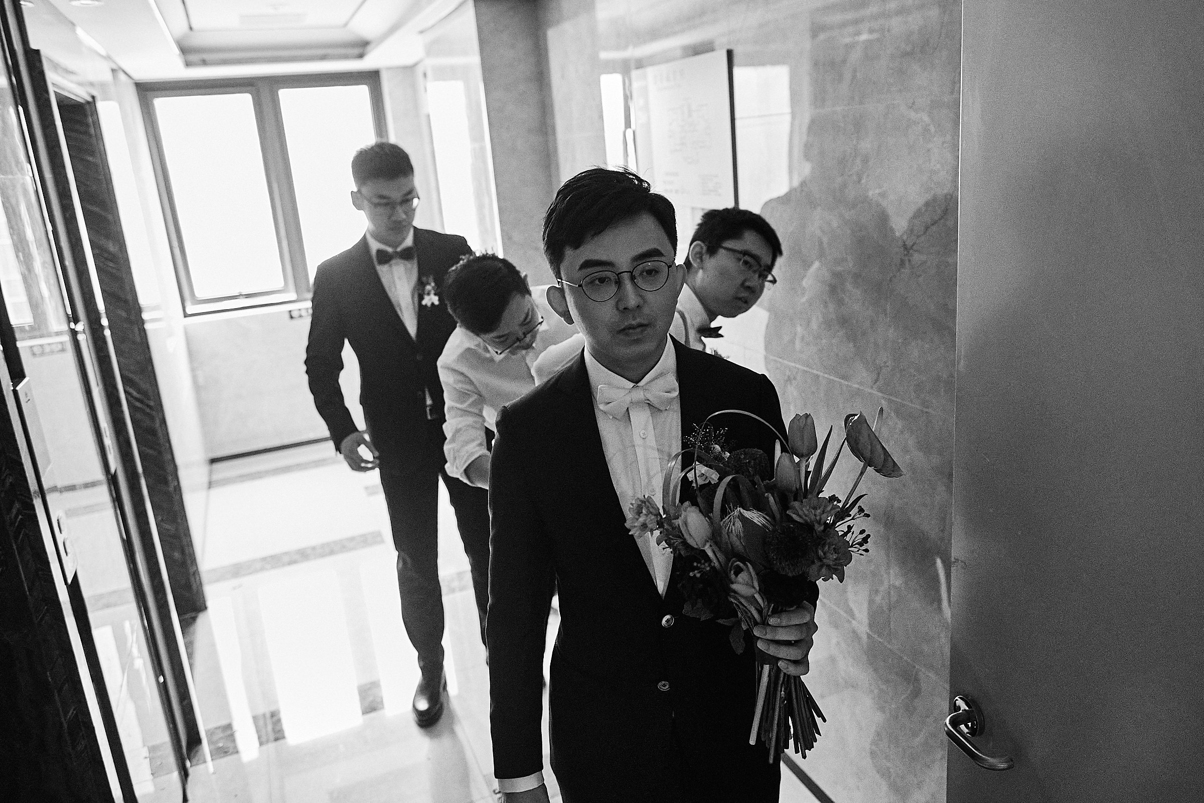 Groom And Groomsmen Prepare To Enter To Pick Up The Bride
