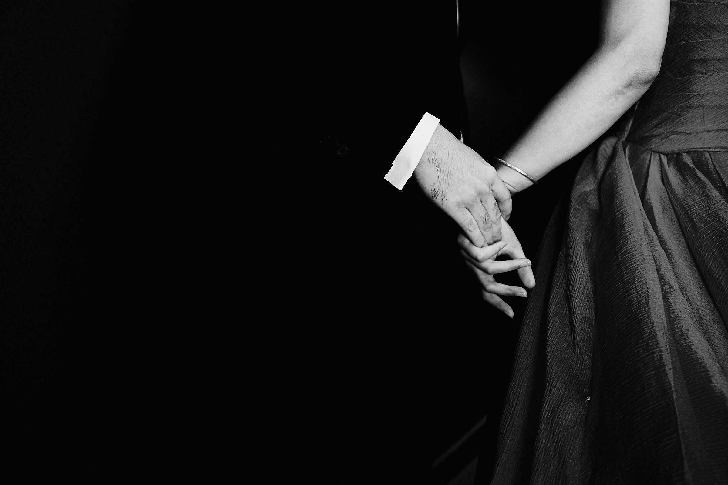 Groom Holds Brides Hand In Black And White