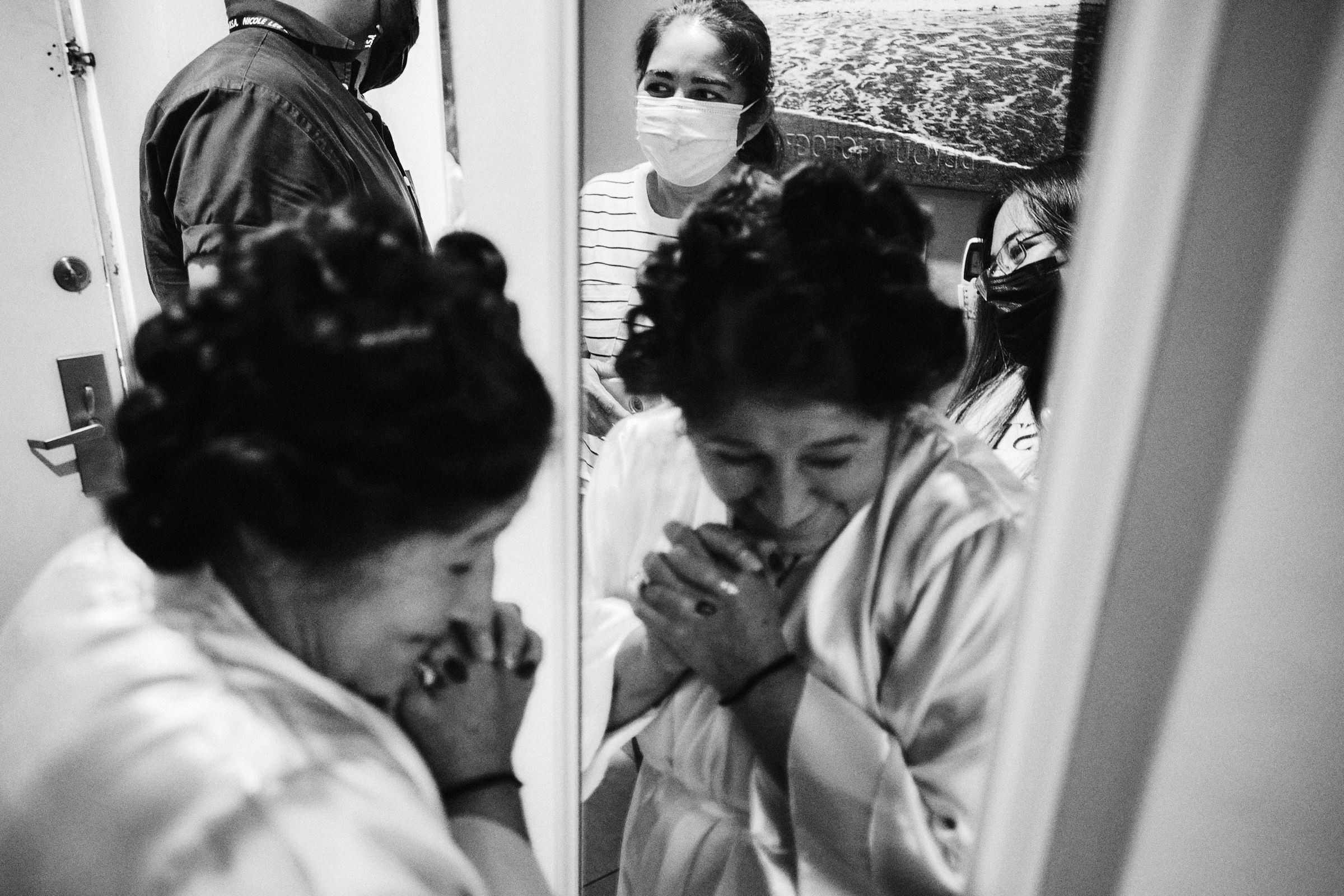 Mom Of The Bride Happily Walks In Front Of Mirror In Black And White