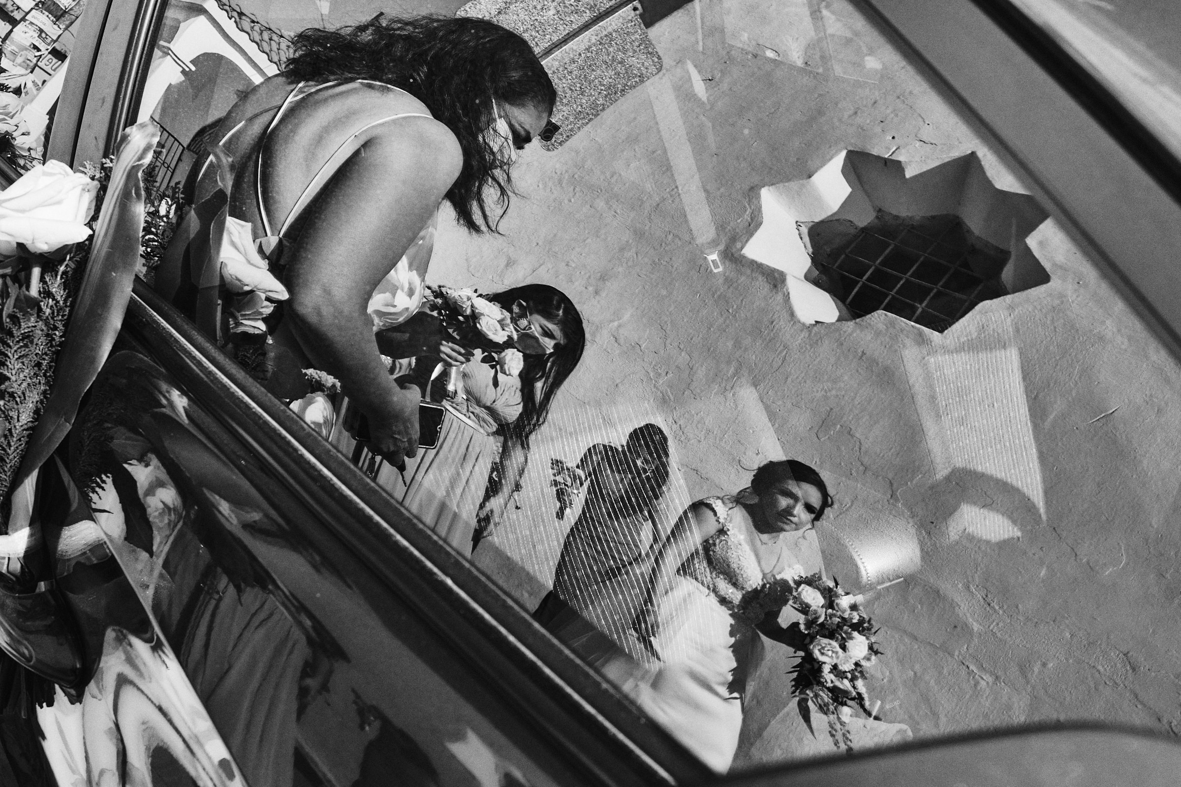 Reflection On Car Glass Of Bride And Her Bridesmaids In Black And White