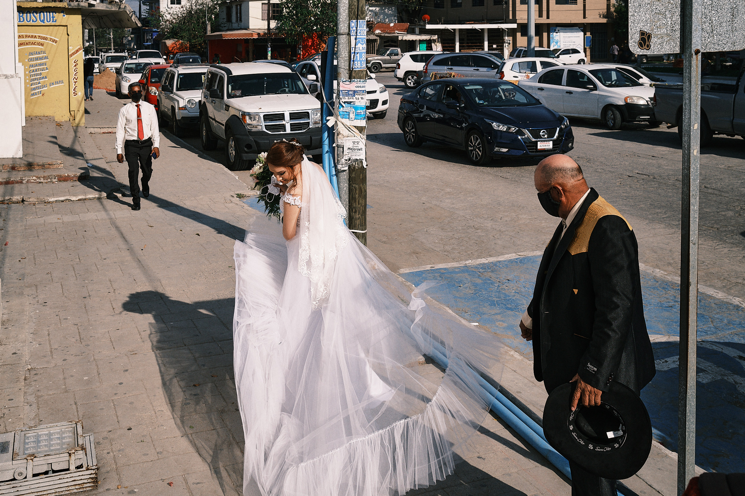 Father Of The Bride Helps Her Fix Her Dress Before Entering The Ceremony Of Mexico Wedding