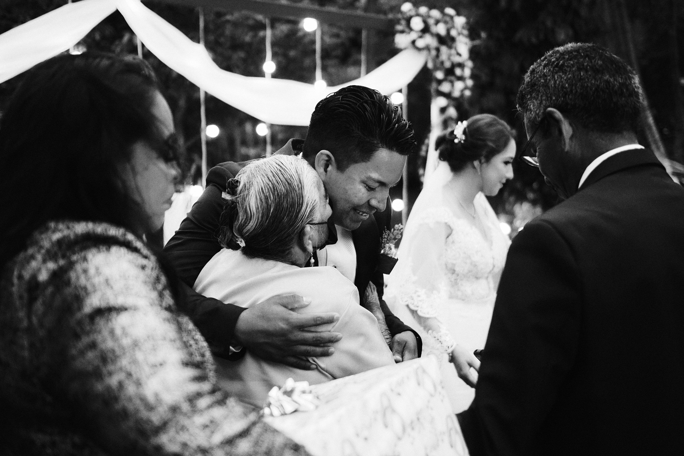 Grandmother Of Groom Gives Him A Kiss As She Congratulates Him In Wedding In Mexico