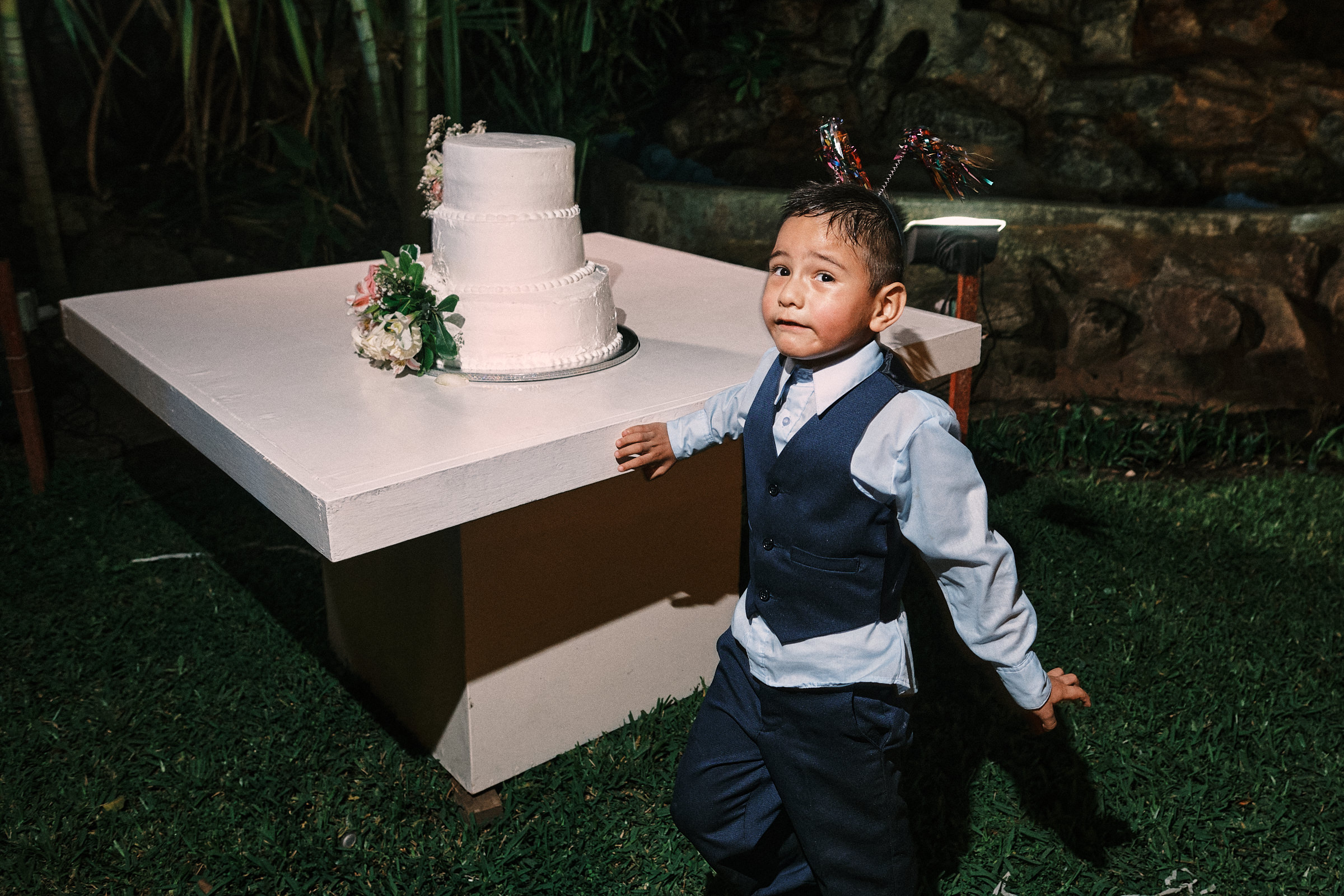 Little Boy Next To Wedding Cake