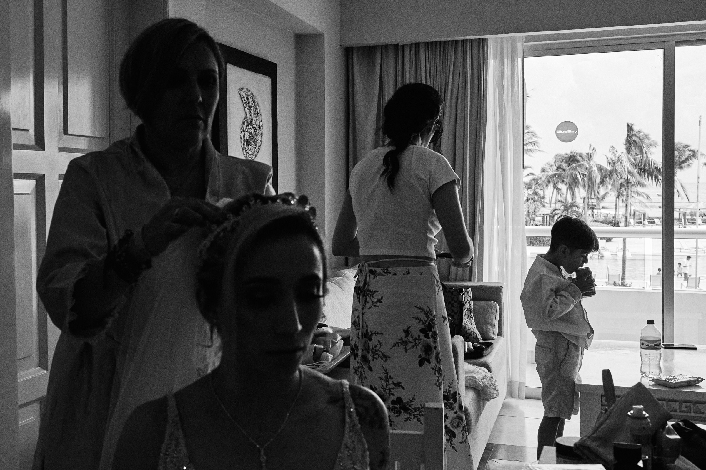 Bride Does Her Hair As Her Son Is In Background Black And White