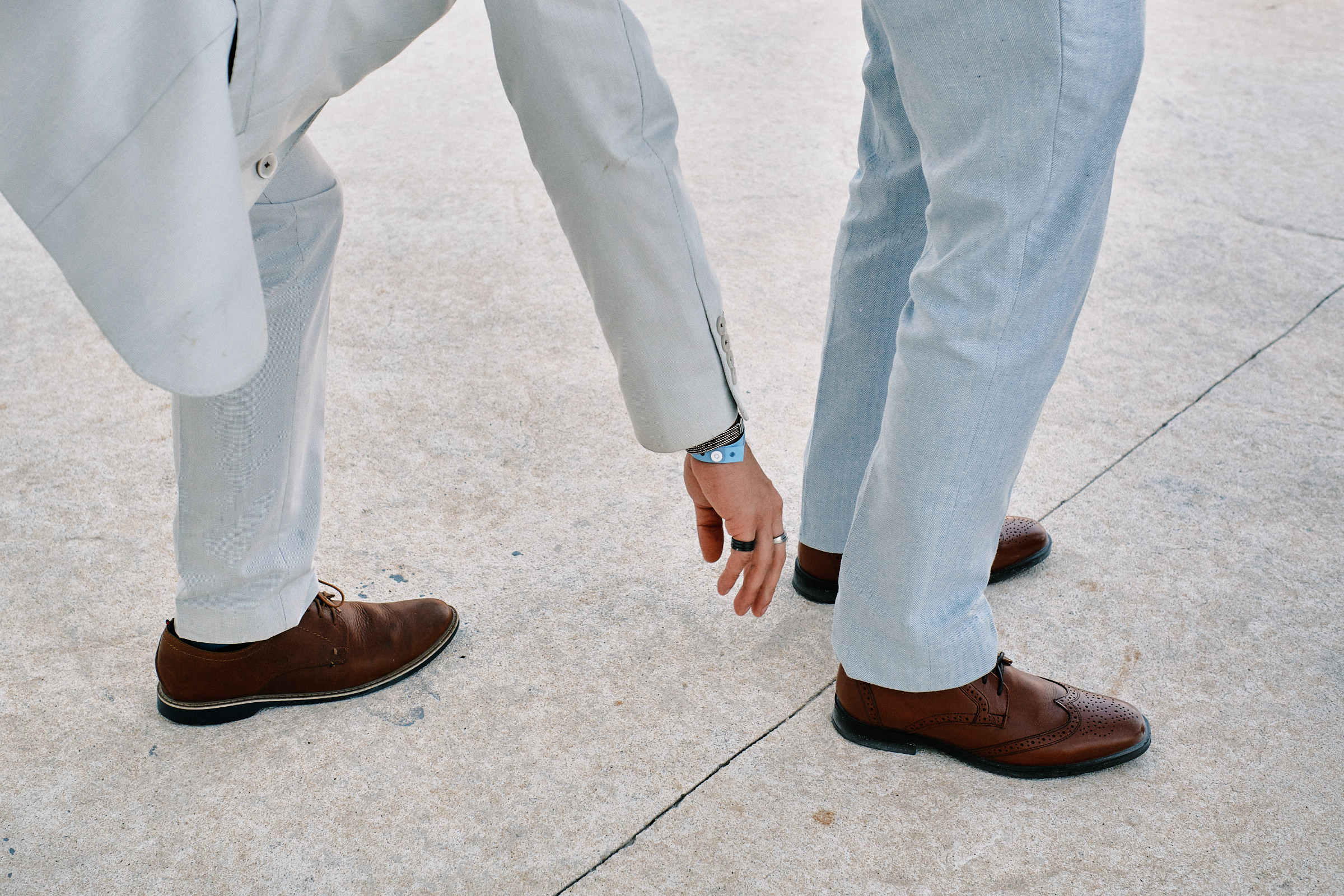 Groomsmen Help One Another To Fix Their Attire