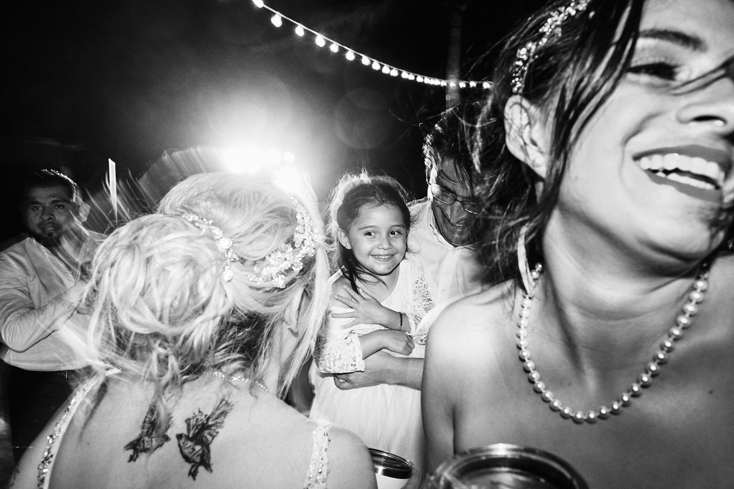 Energetic Photo Of Wedding Guests Dancing In Black And White