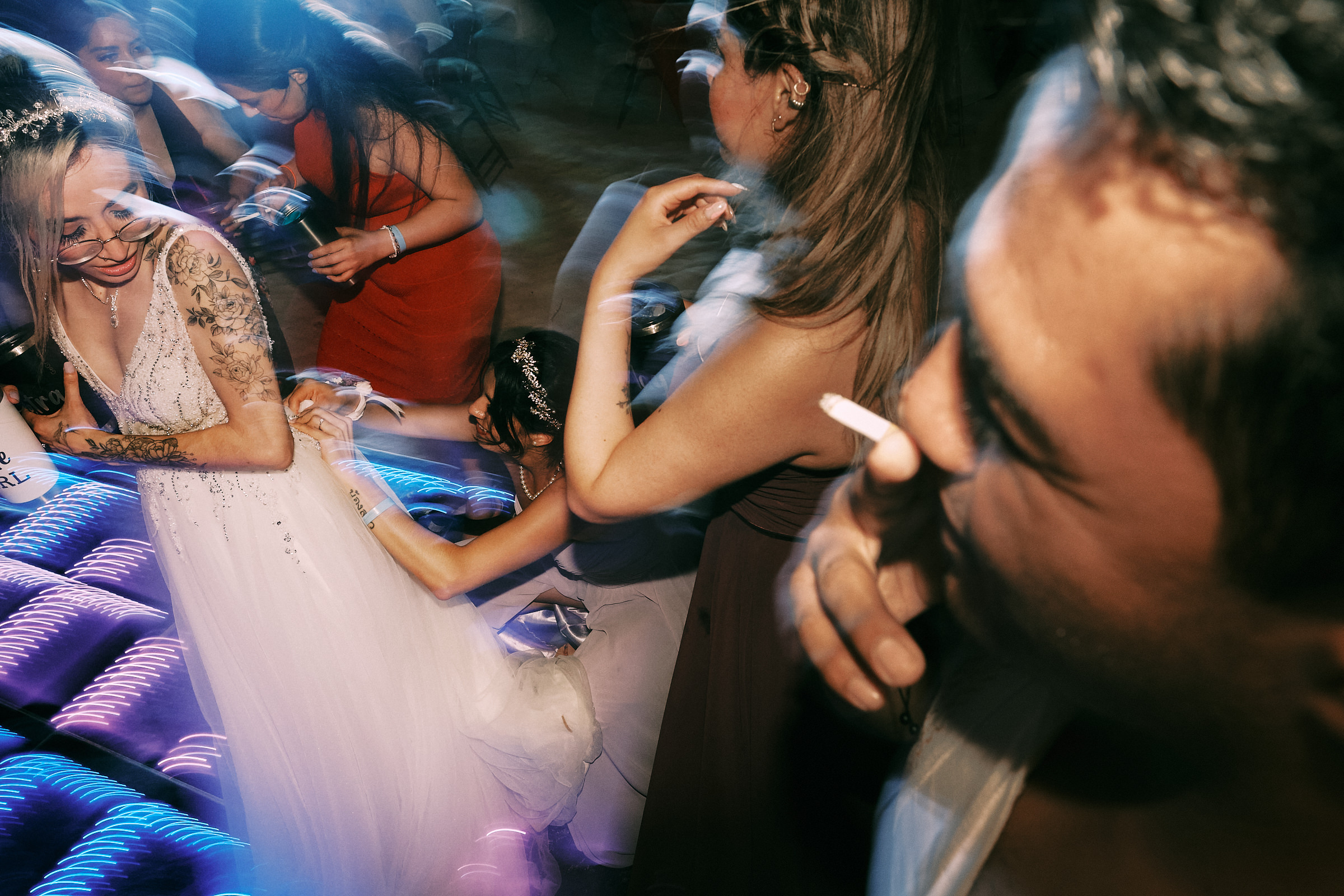 Bride Gets Her Dress Fixed As Everyone Else Dances