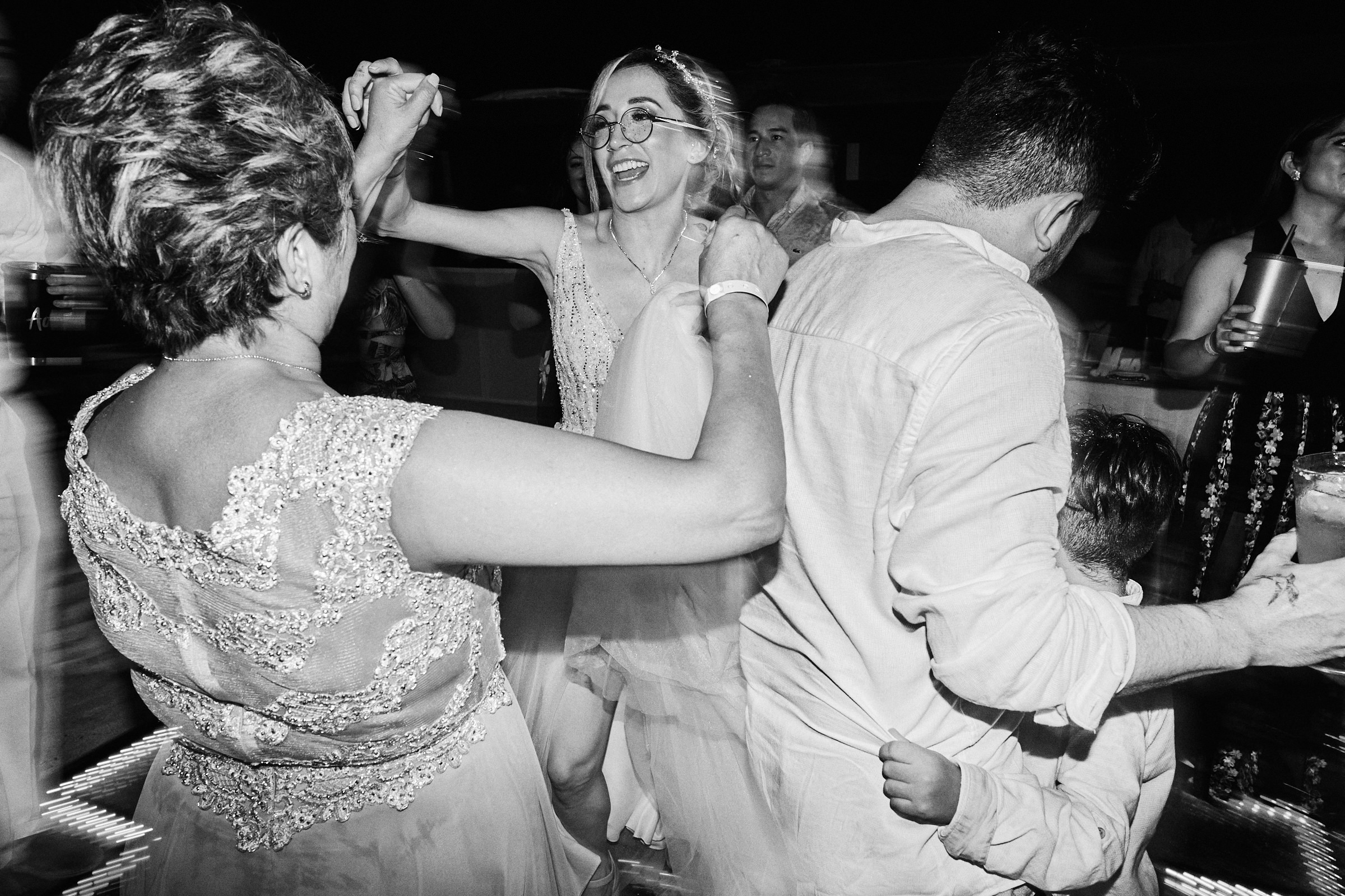 Bride And Groom Dance With Family At Their Reception