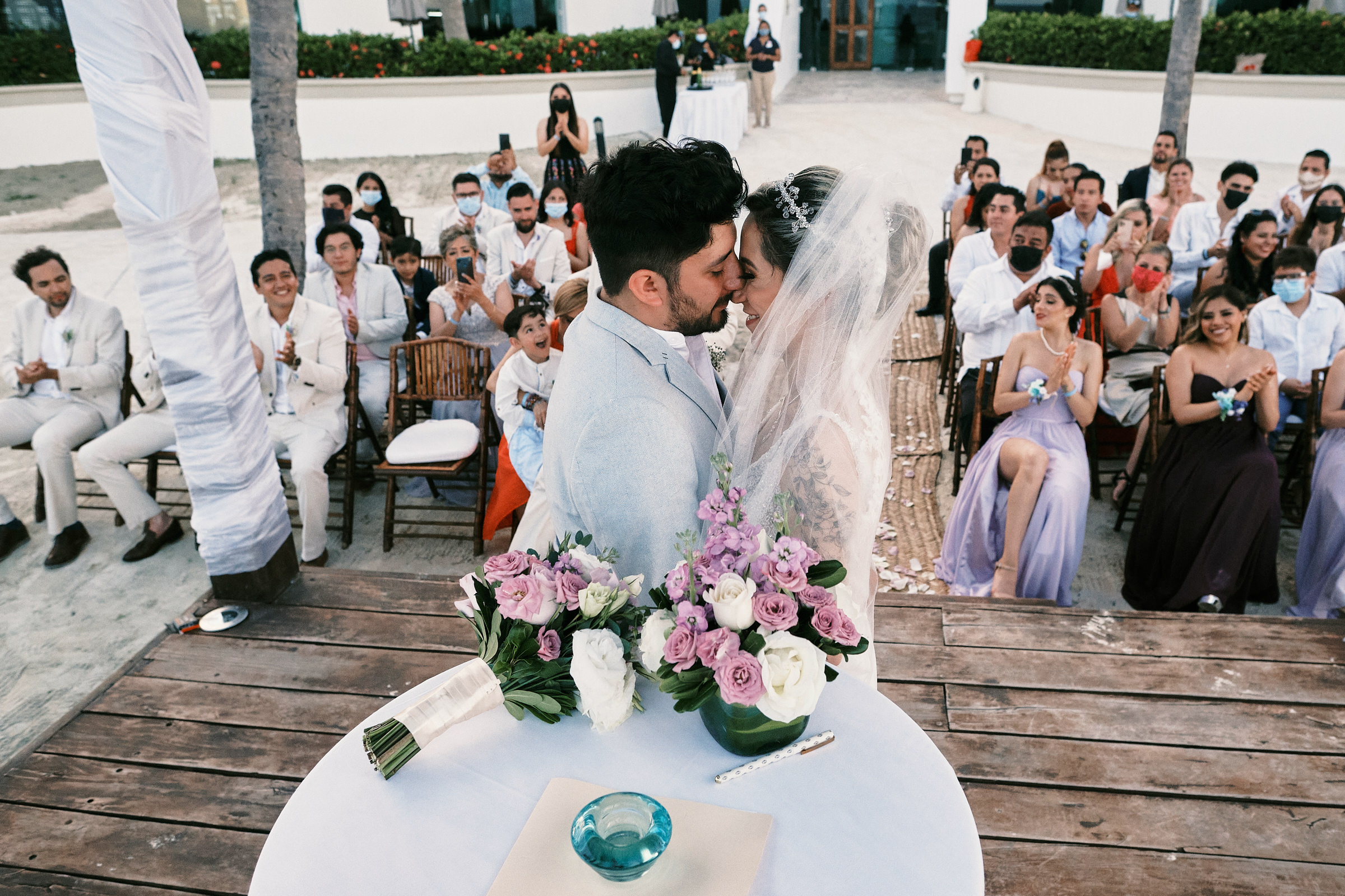 https://www.skillshare.com/classes/Mastering-Golden-Hour-Portrait-Photography/2136745324 bride and groom face one another in front of guests and family in destination wedding at playa del carmen mexico bluebay grand esmeralda