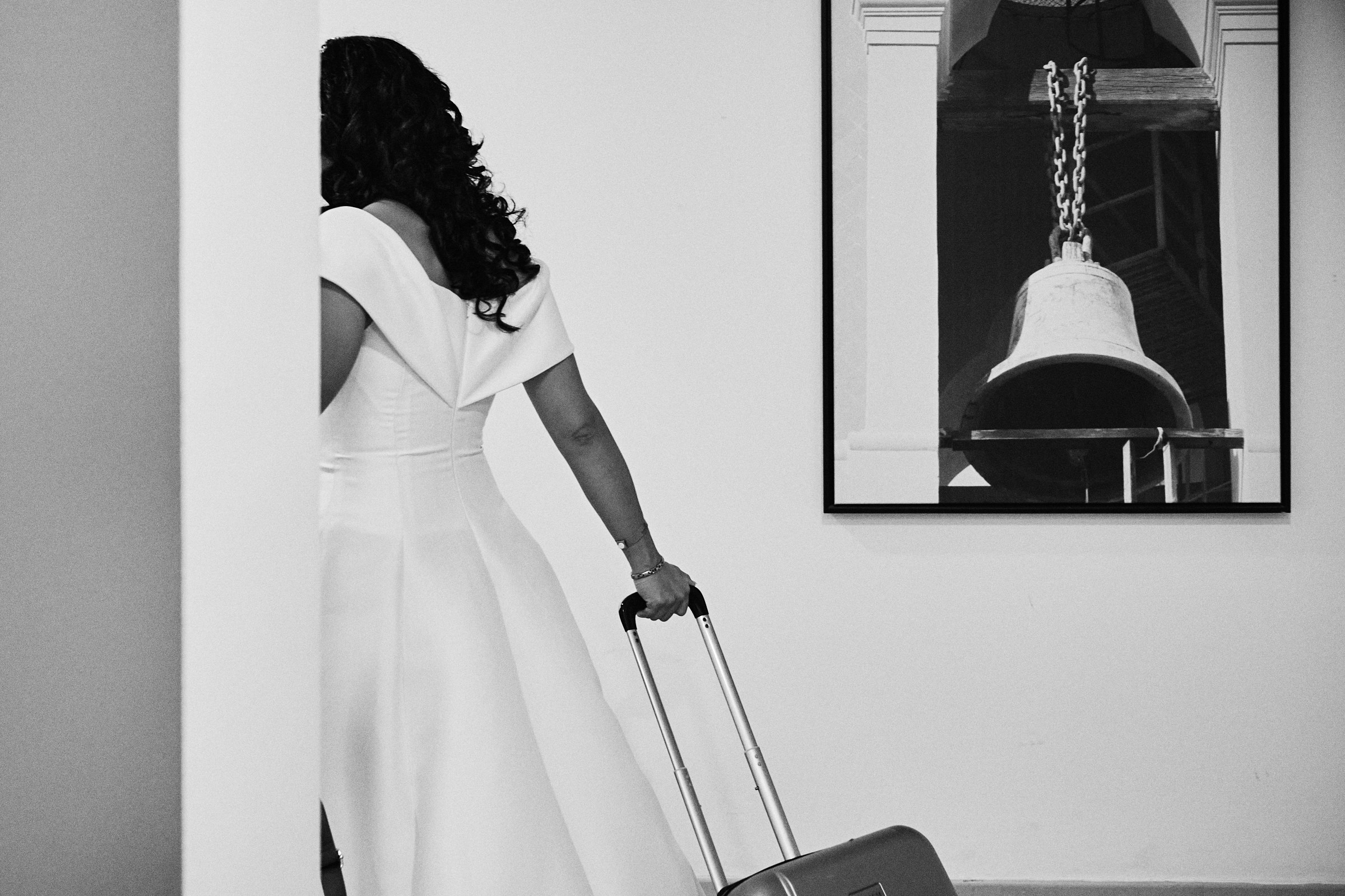 Bride Walks Away From Getting Ready At Pueblo Bonito Hotel While Bell Photo Is On The Wall