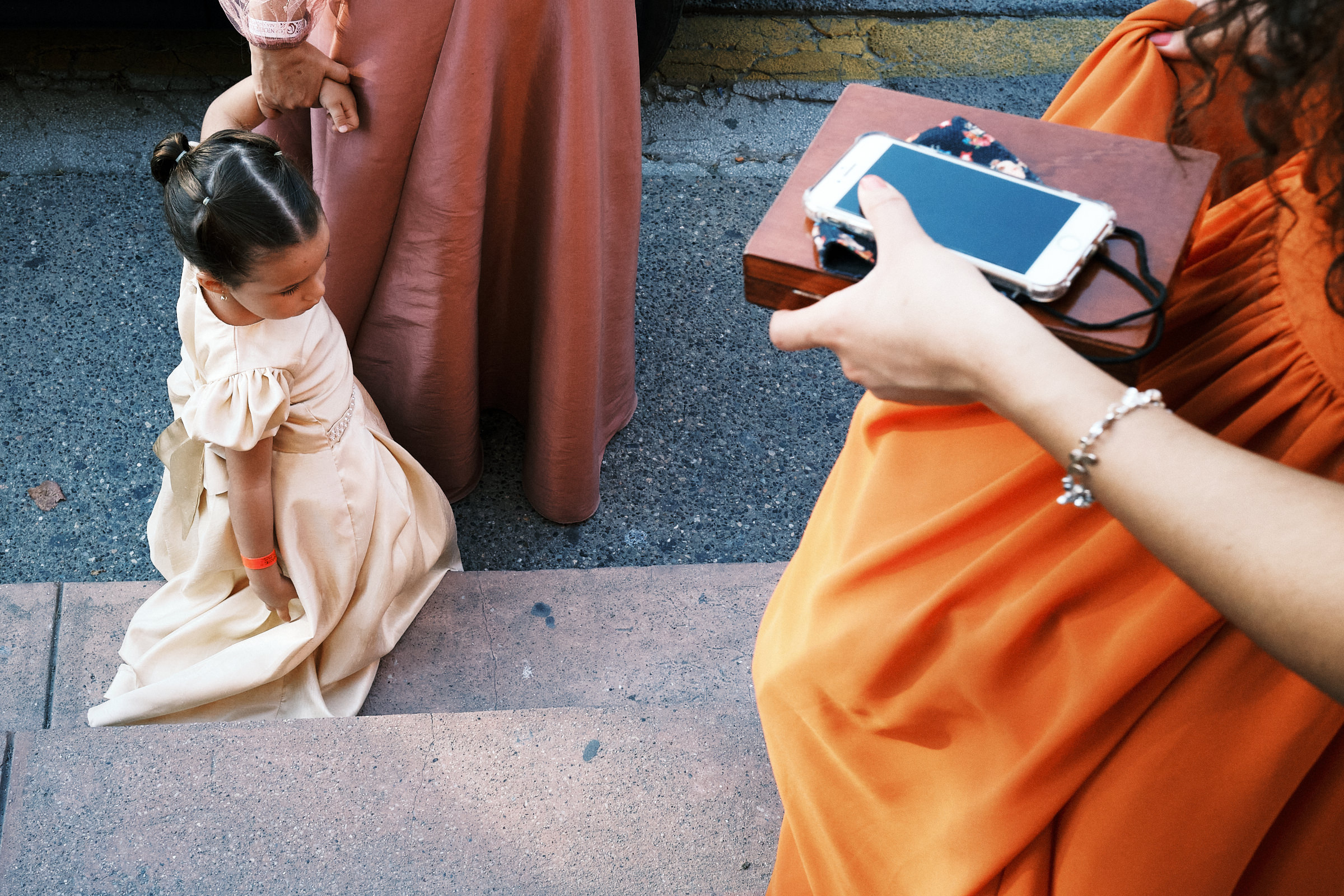 Young Girl Holds Hand Of Mom After Wedding Ceremony