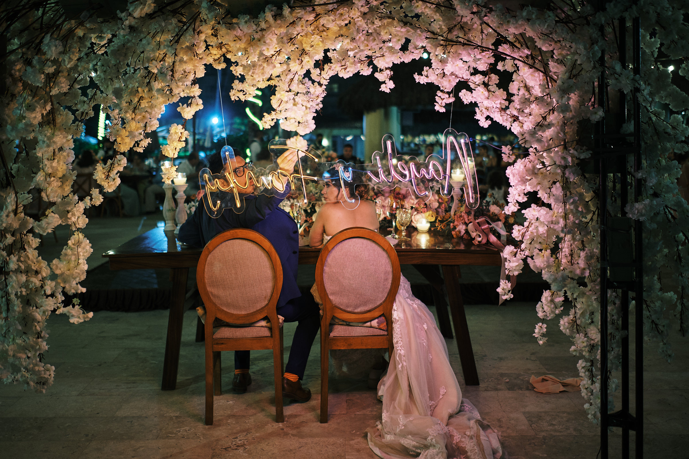 Groom Fixes Decorations Behind Wedding Table