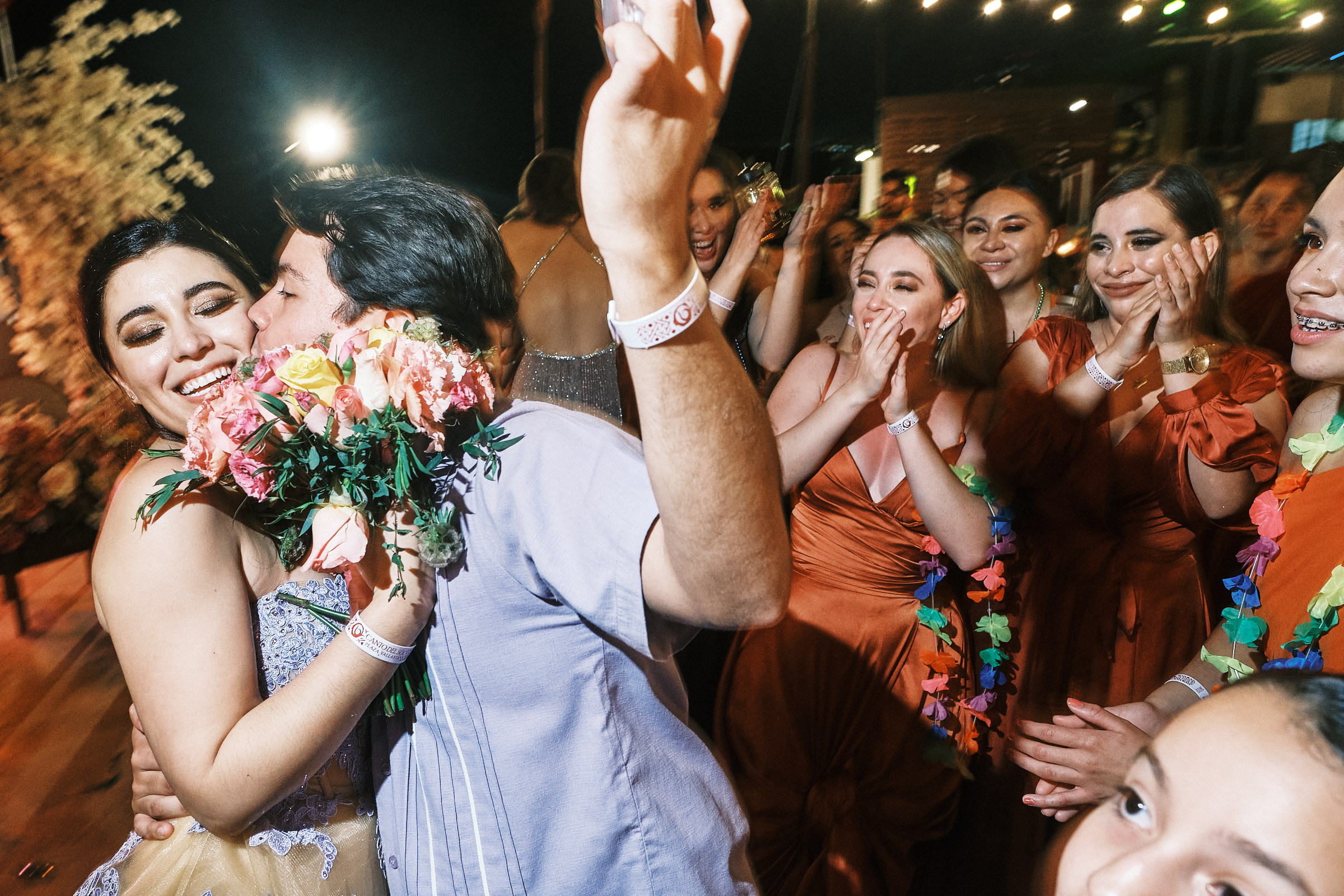Sister Of The Bride Being Kissed On The Cheek While Others Watch