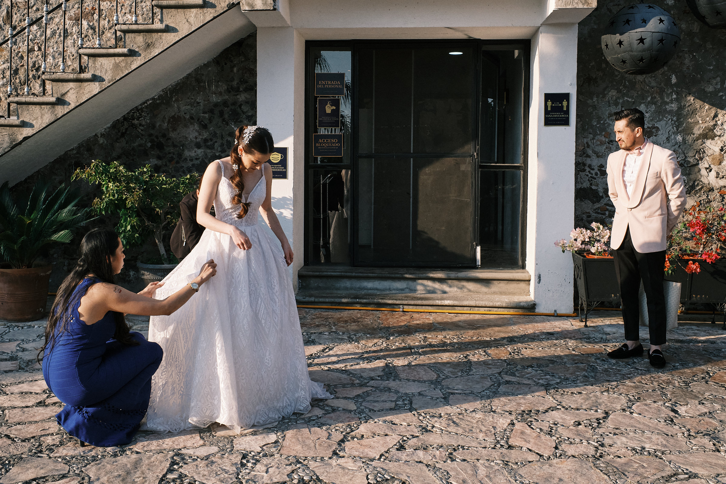 Bride Stops To Fix Her Dress Prior To The Entrance At Reception